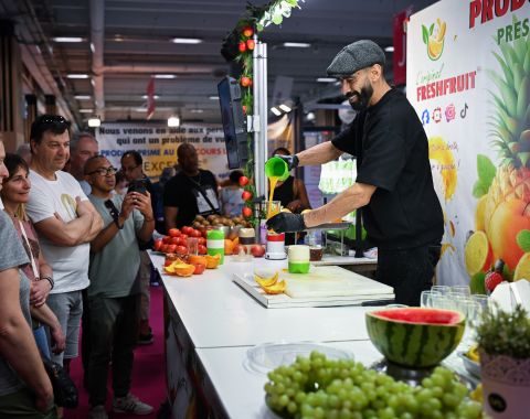 Chef en démonstration prépare un jus de fruits frais devant un public attentif sur un stand. Made in Paris par Foire de Paris